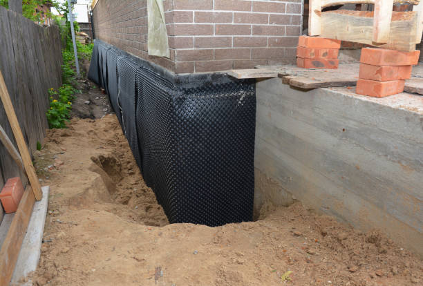SJ Waterproofing Pros technician performing targeted Basement Waterproofing assessment in Burton, MI